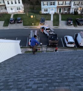 The final sweep of a brand-new roof replacement on a townhome with the Excel Roofing trucks leaving
